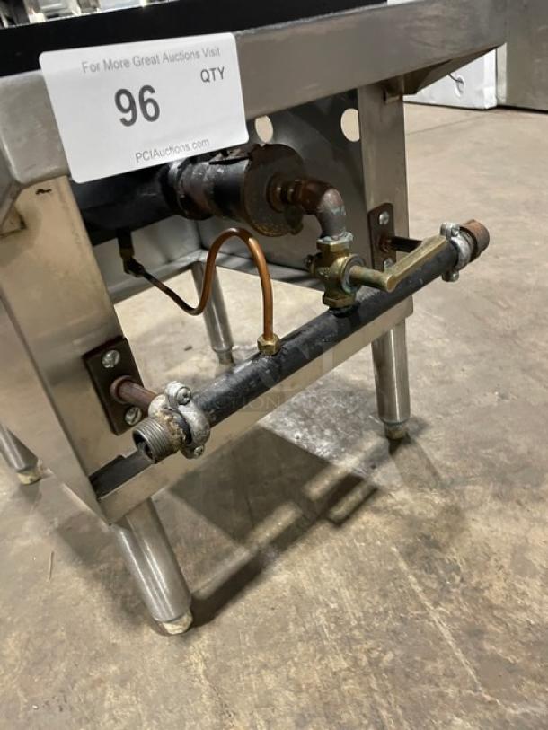 Commercial stainless steel natural gas single burner stock pot range on legs, in used condition, with visible gas connection.