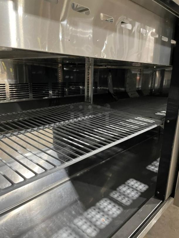 Turbo Air MST-60-24-N refrigerated prep table with stainless steel finish, poly-coated wire rack, and casters.