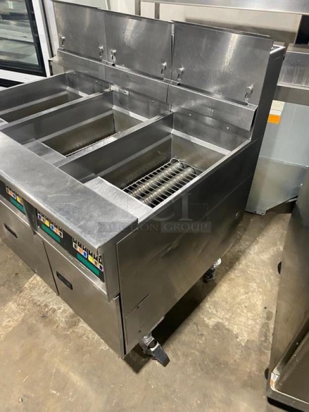 Pitco SSH60 stainless steel commercial triple-bay deep fat fryer, 50 lb capacity, with backsplash and basket hanger, on casters.