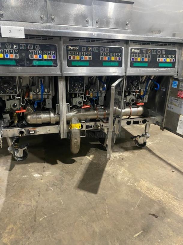Pitco SSH60 commercial stainless steel 50 lb. triple-bay deep fryer system, natural gas, backsplash, basket hanger, on casters.