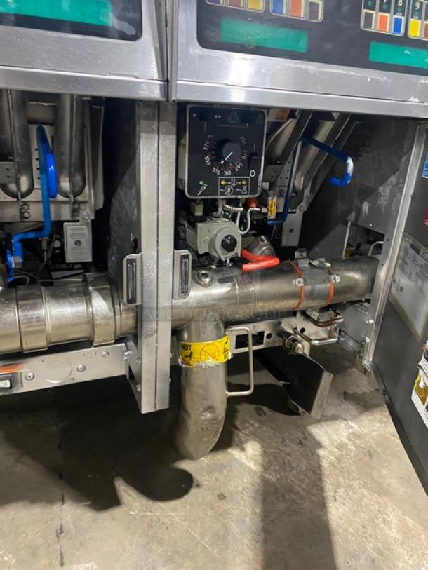 Pitco SSH60 commercial stainless steel 50 lb. triple-bay fryer system, natural gas-powered, with backsplash, basket hanger, on casters.