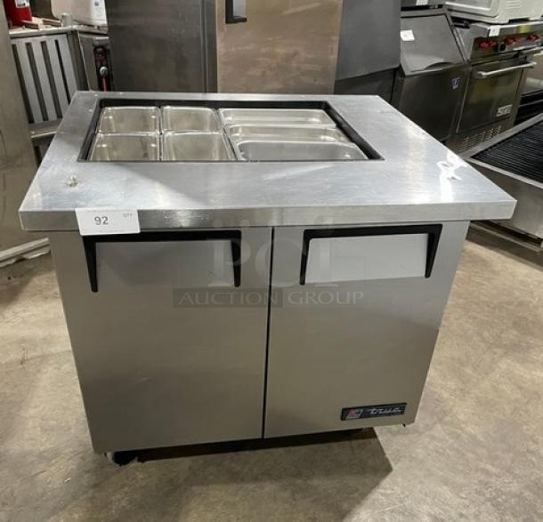 True TSSU-36-12M-B stainless steel 2-door refrigerated prep table with pans, 115V, on casters, commercial use.