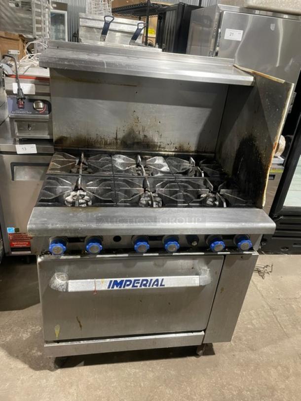 Imperial stainless steel 6-burner gas range/oven combo with back and side splash, overhead salamander shelf, wired oven rack, on casters.