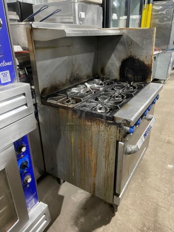 Imperial stainless steel 6-burner range/oven combo. Features back/right-side splash, overhead salamander shelf, wired oven rack, on casters.