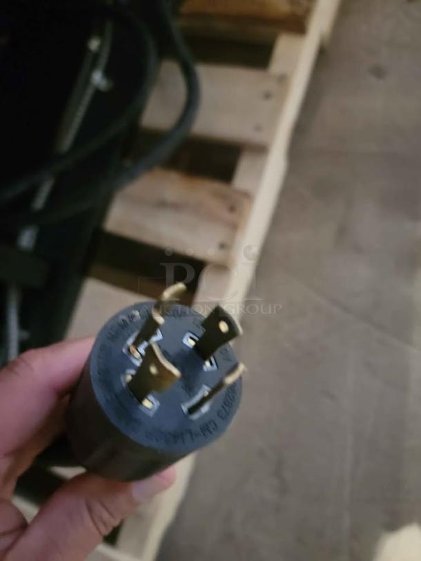 Close-up of a power plug associated with the RPI Industries Bandit Air Screen refrigerated merchandiser model SCRFC2728R.