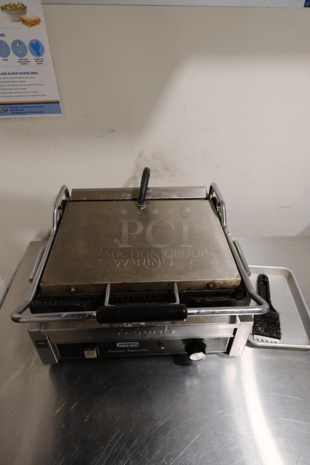 Waring Commercial Panini Press Model WPG250 with cast iron grooved plates. Slight wear visible. Ideal for cafes and restaurants.