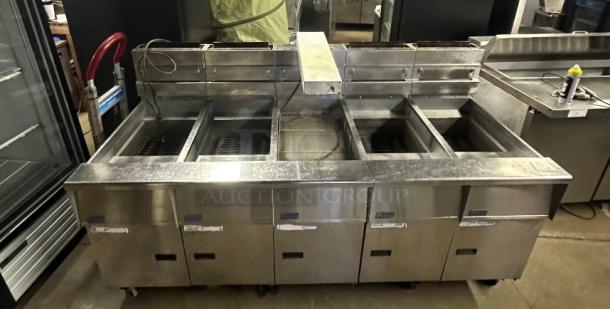 Pitco SSHBN55 high-efficiency 4-bank gas fryer with built-in filtration system. Stainless steel, used condition, ideal for commercial kitchens.