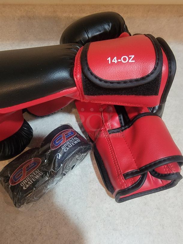 Red and black OG Martial Arts 14oz boxing gloves with Velcro straps and sealed matching hand wraps. New condition.