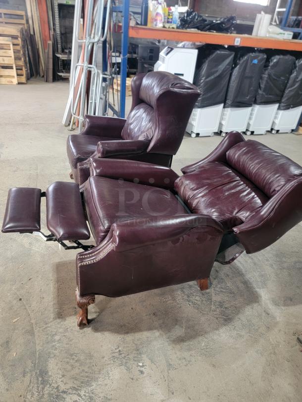 Bradington-Young leather wingback recliners, burgundy upholstery, nailhead trim, turned wooden feet, manual push-back, 2010 model.