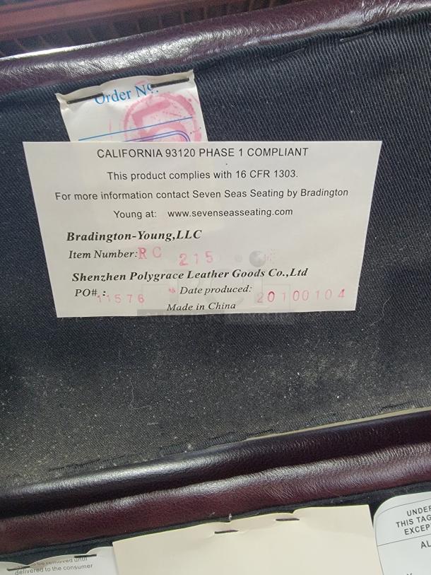 Bradington-Young RC215 tag; compliance info, manufacturer details. Model RC215, made in China, 2010 production date.