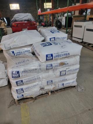 Pallet of approximately 20 bags of Yara Urea Fertilizer 46-0-0, each weighing 55 lbs, stored in a warehouse.