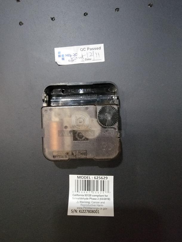 Howard Miller Aviator 625-629 wall clock mechanism; includes labels for model, safety compliance, and warnings.