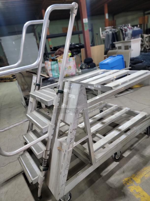 Heavy-duty 3-step warehouse ladder cart by New Age Industrial, made of rust-resistant aluminum with safety design, on wheels.