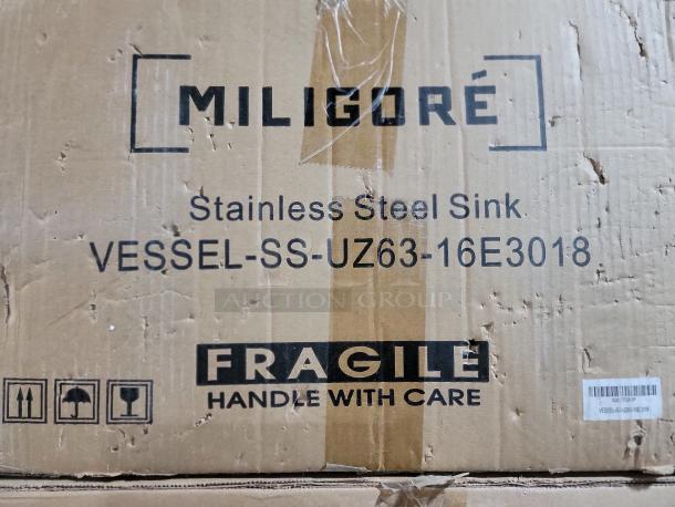 Brand new Miligore VESSEL-SS-UZ63-16E3018 stainless steel sink box, labeled "Fragile."