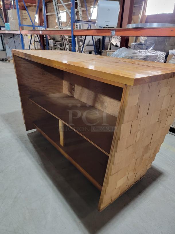 Custom-built wood bar with 6ft cedar shake finish, rustic design, ideal for man cave or patio. Solid wood, rugged appeal.