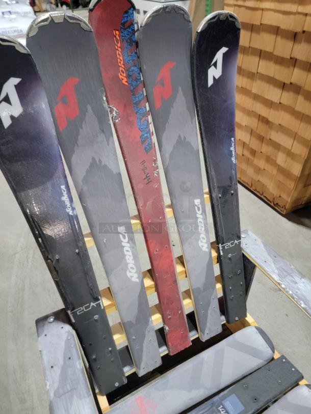 Upcycled Adirondack chair made from Nordica skis, featuring a colorful and rustic design. Ideal for outdoor or ski-themed decor.