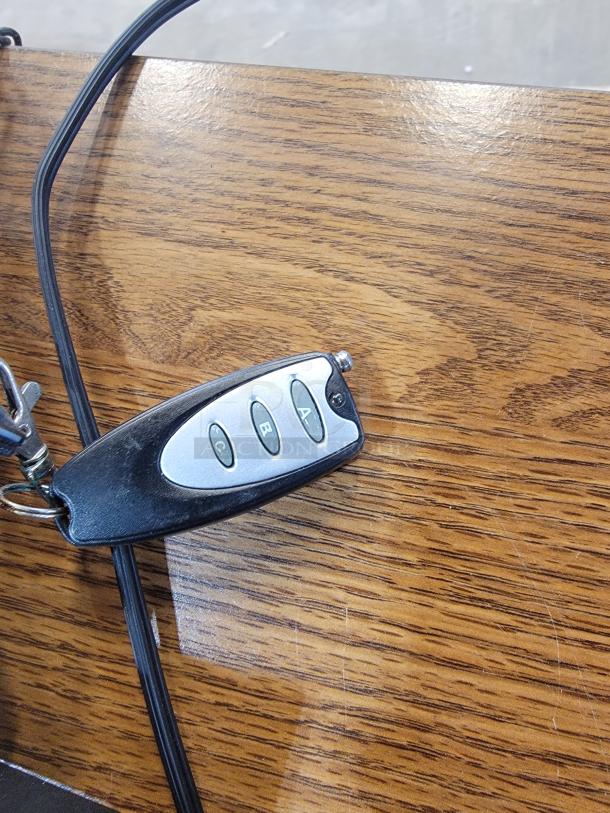 Remote control for Element Lux Neon LED OPEN Sign, featuring four black buttons labeled A, B, C, and a power symbol.