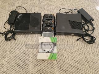 Two Xbox 360 S consoles with controllers, power supplies, headset, and chat pad on a carpet. Complete gaming bundle.