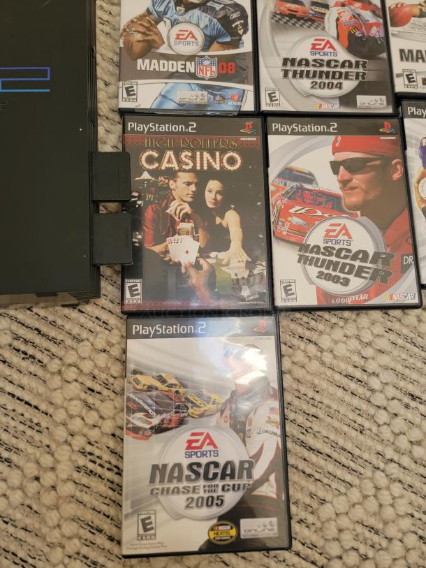 Sony PlayStation 2 Fat Model with 12 games, including Madden NFL 08 and NASCAR Thunder 2004. Includes two controllers.