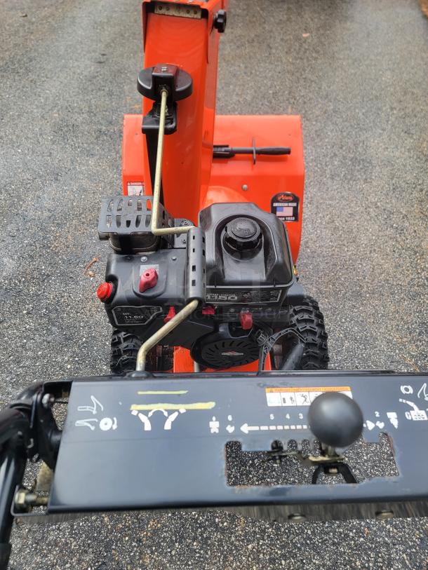 Ariens Deluxe 24" Snow Blower, Model 921011, excellent condition, two-stage design, controls and chute lever visible.