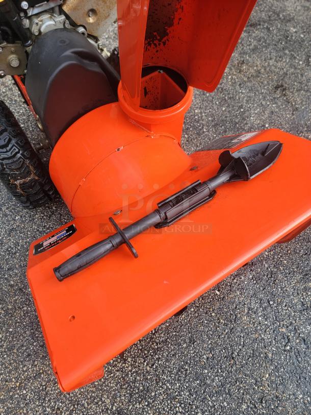 Ariens Deluxe 24" snow blower, model 921011, in excellent condition. Features durable build and visible auger shovel.