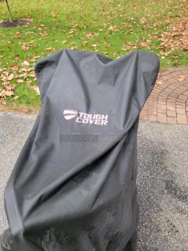 Ariens Deluxe 24" Snow Blower covered with a Tough Cover. Label reads "Tough Cover". Model 921011, excellent condition.