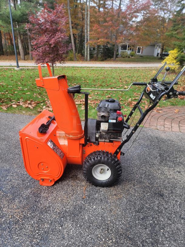 Ariens Deluxe 24" snow blower model 921011 in excellent condition, features durable two-stage mechanism, ideal for snow clearing.