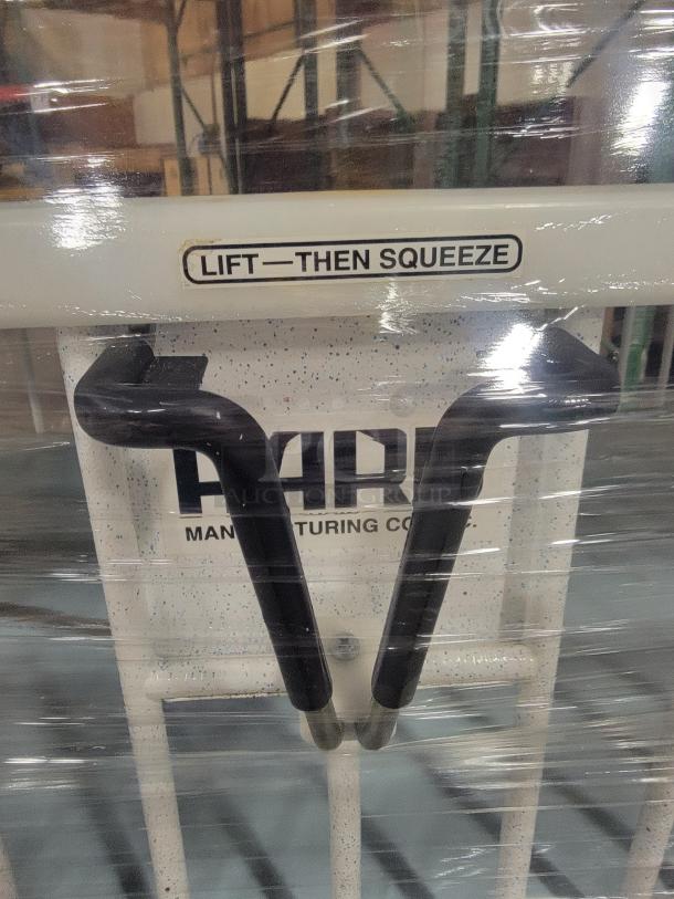 Heavy-duty adjustable frame by Hard Manufacturing, model General Pediatric. Hospital-grade steel with manual crank Hi-Lo system. "Lift—Then Squeeze" label visible. Ideal for workshops or man caves.