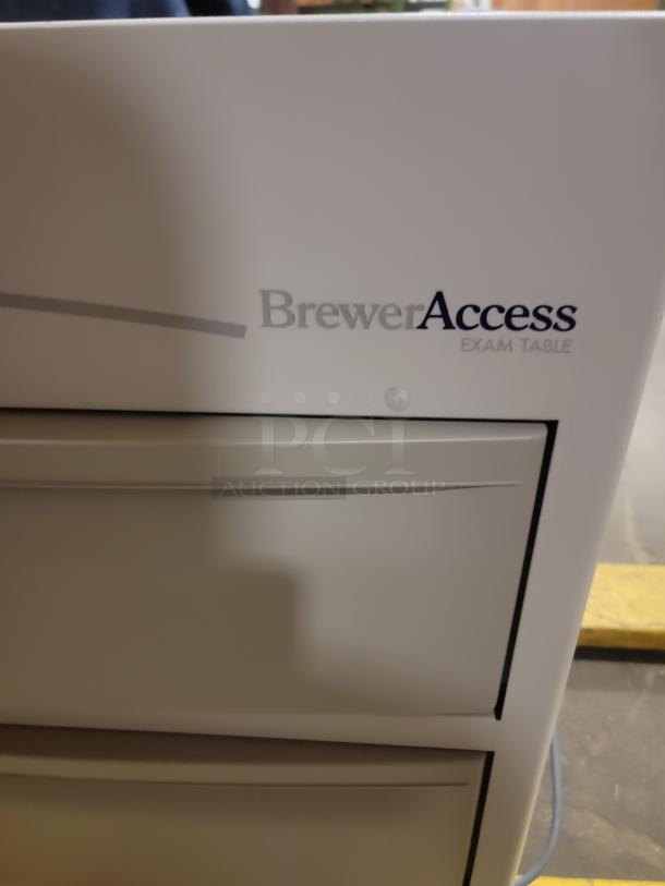 Brewer Access Exam Table, model 104, sturdy design, versatile uses. Ideal for creative projects. Visible logo on side panel.
