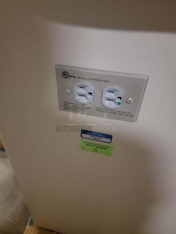 Riter/Brewer Model 104/Access examination table, UL listed, with power outlets and safety check label from Mid Coast Hospital.