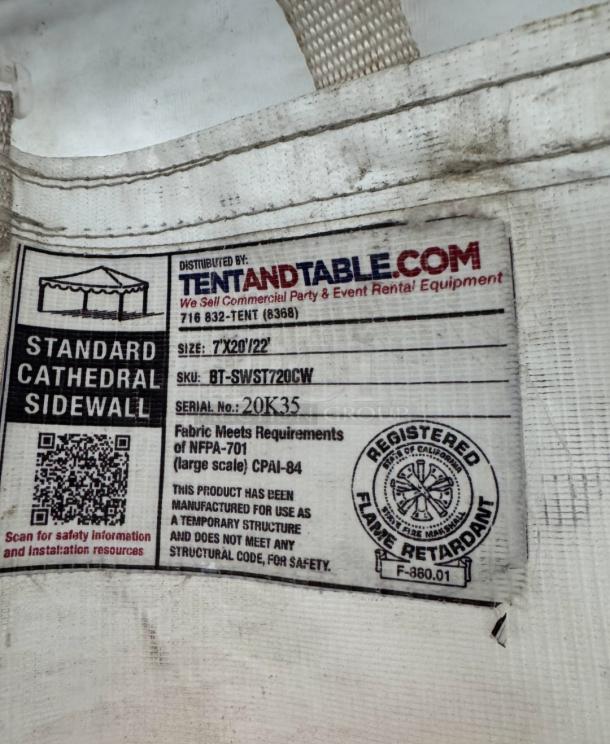 Tag on premium West Coast Frame Tent by Tent and Table, model BT-FW24WT3P. Shows compliance details and flame retardant certification.