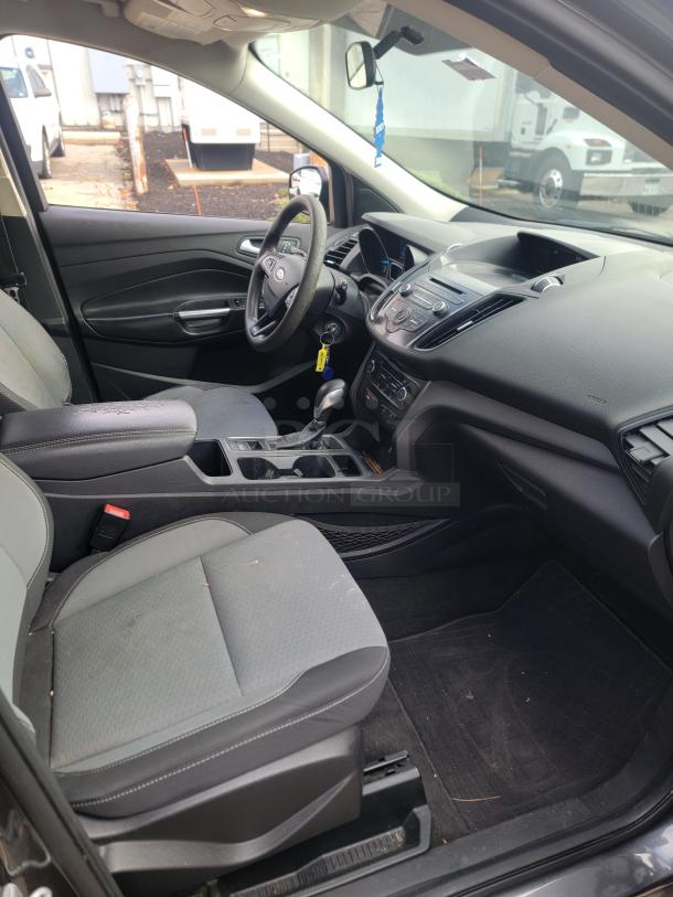 Interior of 2018 Ford Escape SE 4WD. Grey fabric seats, clean dashboard with visible controls, all in well-maintained condition.