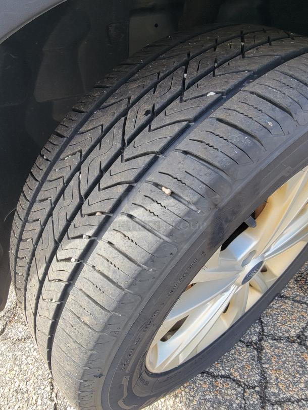 Close-up of 2018 Ford Escape SE tire, showcasing tread depth and all-wheel drive capability for winter readiness.