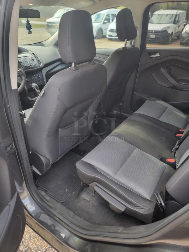 2018 Ford Escape SE 4WD interior, featuring black fabric seats in good condition. Spacious rear seating area.