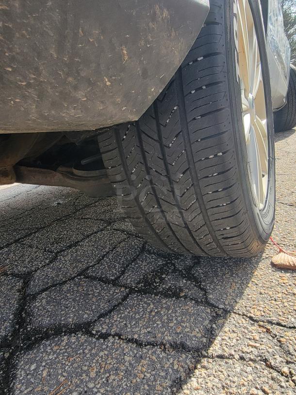 Close-up of a 2018 Ford Escape SE 4WD tire on pavement; tread appears in good condition, ideal for winter use.