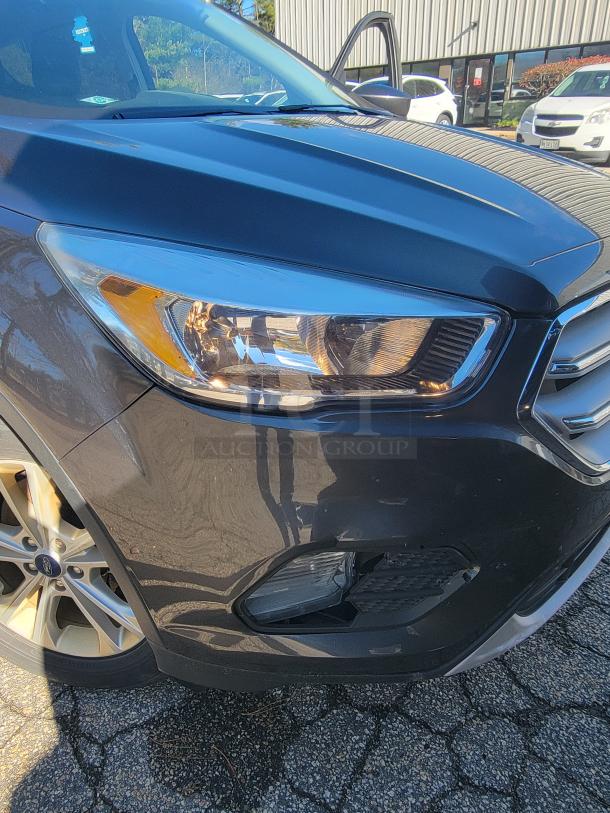 2018 Ford Escape SE 4WD SUV front view, black exterior, alloy wheels, well-maintained condition, visible headlight and grille.