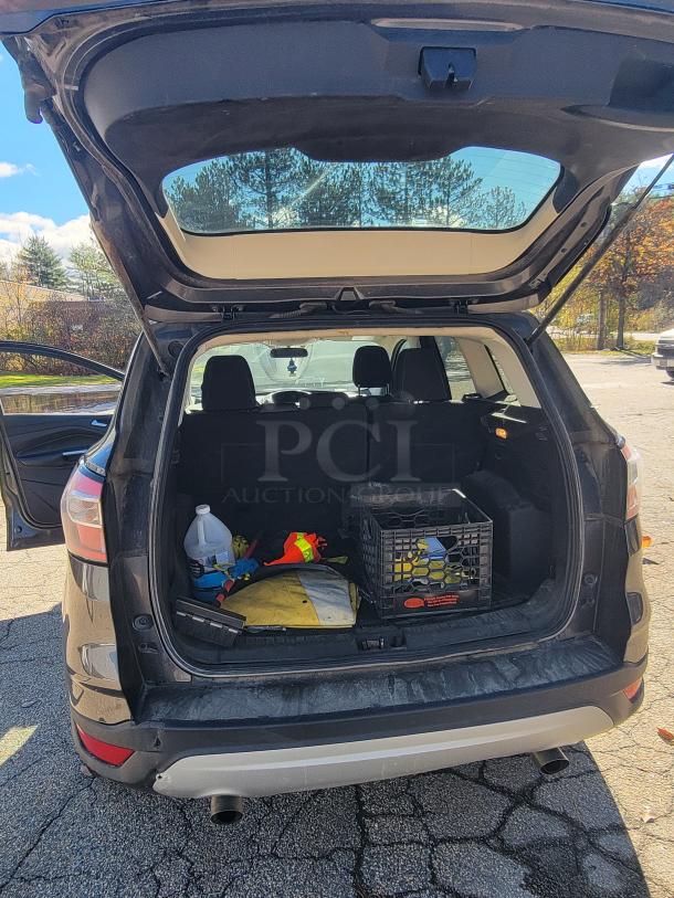 2018 Ford Escape SE 4WD trunk open, showing winter gear and crate. Former security fleet vehicle. Low mileage, needs new battery.