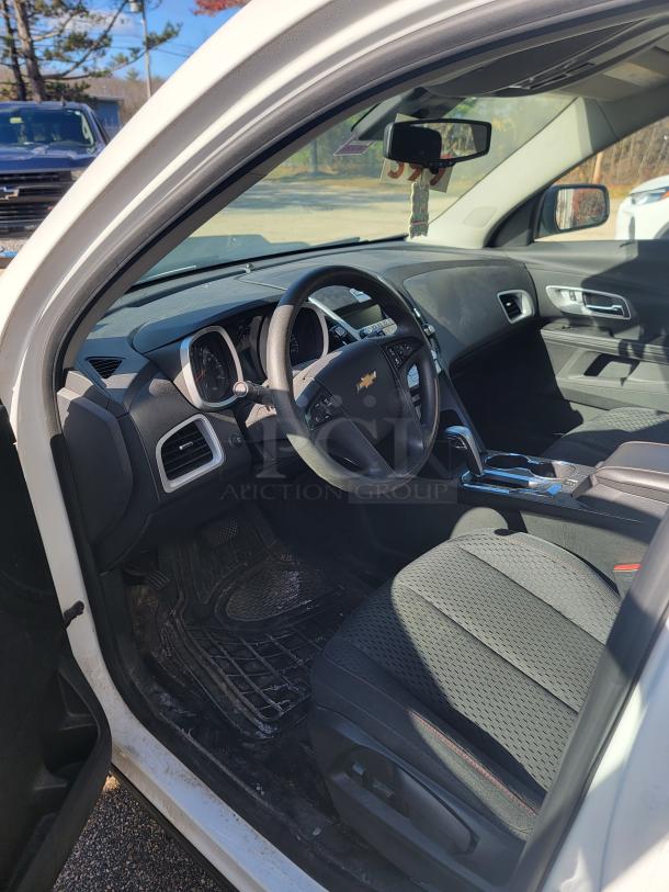 2015 Chevy Equinox SUV interior, well-maintained. Black upholstery, steering wheel with logo. Former medical fleet vehicle, non-running.
