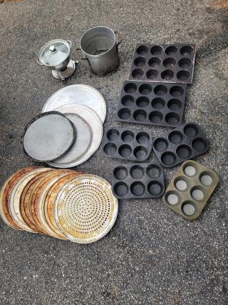 Huge lot of used kitchenware including an 8-inch chafing dish, large pots, muffin pans, pizza screens, and baking trays.
