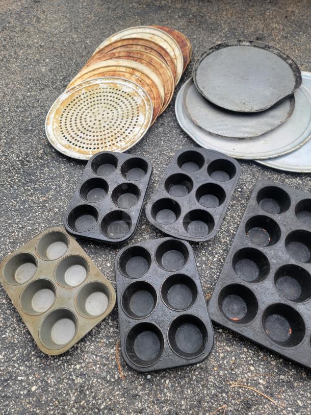 Used baking pans, pizza screens, muffin trays, and pots in mixed condition, ideal for business or upcycling.