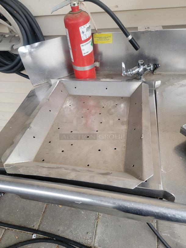 Heavy-duty 8' stainless steel workstation with raised backsplash, ideal for food prep or as a workbench, in excellent condition.