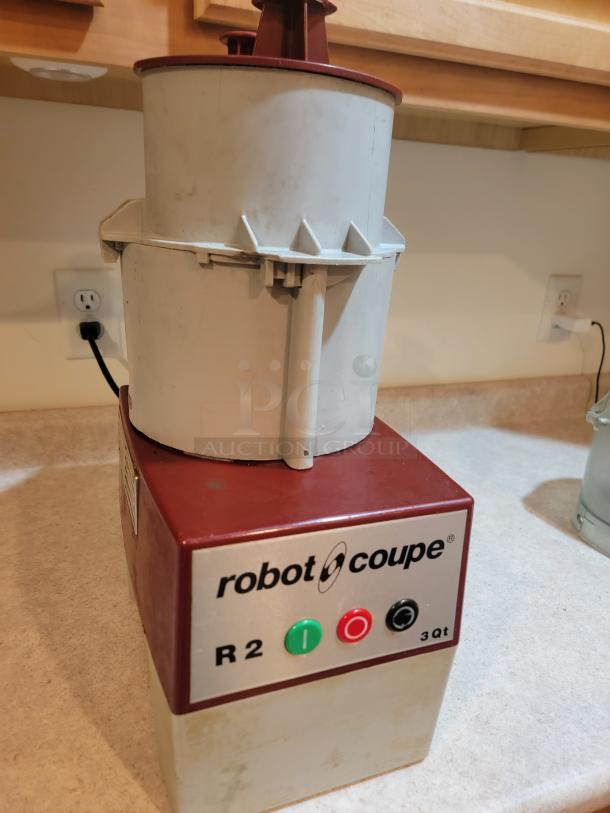 Used Robot Coupe R2NCLR commercial food processor, 3-quart capacity, durable 120V motor, includes bowl and attachments, tested.
