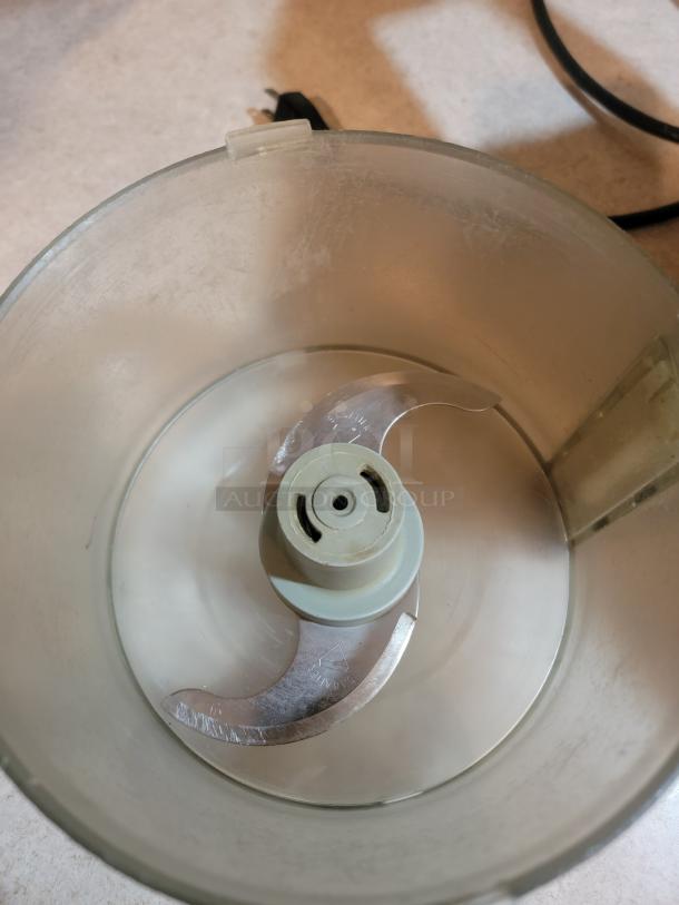 Robot Coupe R2NCLR food processor bowl with S-blade assembly, showing minimal wear, durable commercial-grade quality.