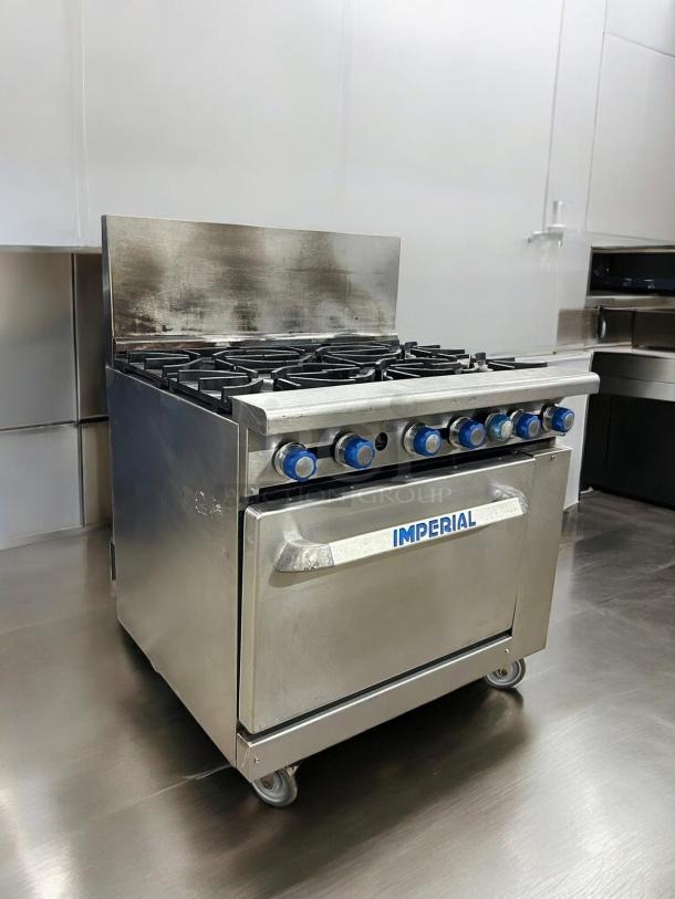 Imperial IR-6 gas range, 6 burners, oven base, stainless steel, excellent condition, Imperial logo on door, blue knobs.
