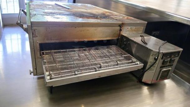 XLT 3240 gas conveyor pizza oven, high-performance, natural gas, excellent condition, fully tested, stainless steel exterior.