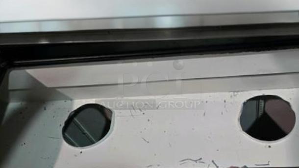 Alt text: Close-up of the True TPP-93 pizza prep table interior, showing openings and a smooth white surface.