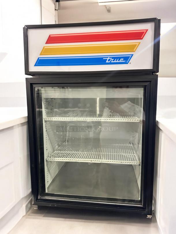True GDM-05-LD glass door merchandiser refrigerator in superb condition, 115V, fully tested, featuring reflective logo.