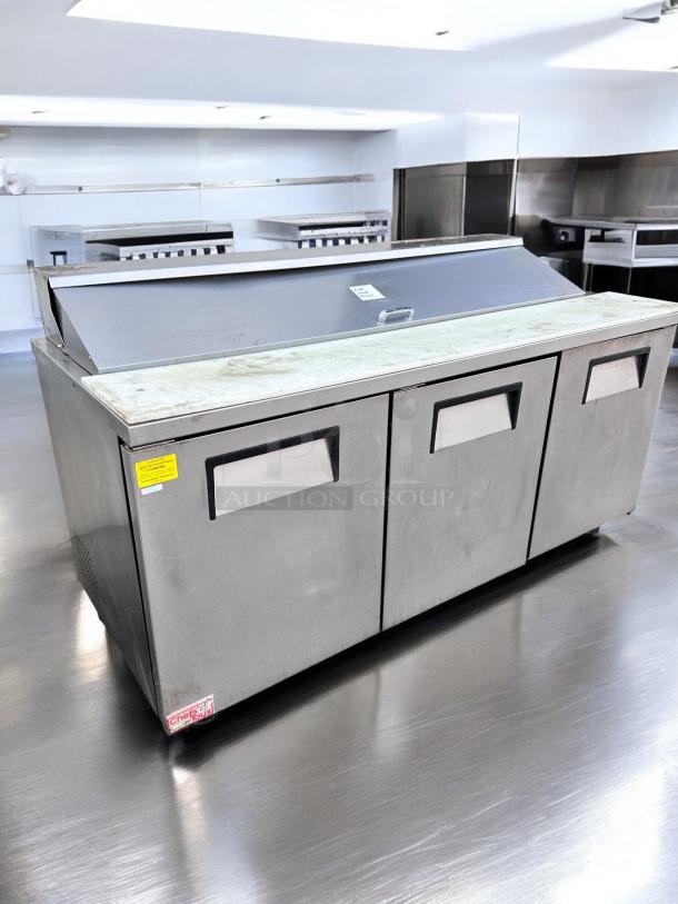 Excellent condition True TSSU-72-18 3-door prep table refrigerator, tested, 115V, stainless steel, with labels.