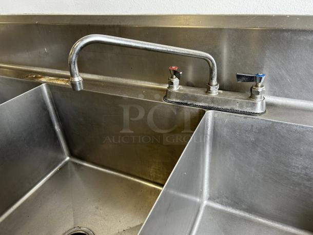 Commercial 3-compartment stainless steel sink with double drainboards, custom fabricated, in great condition, fully tested.