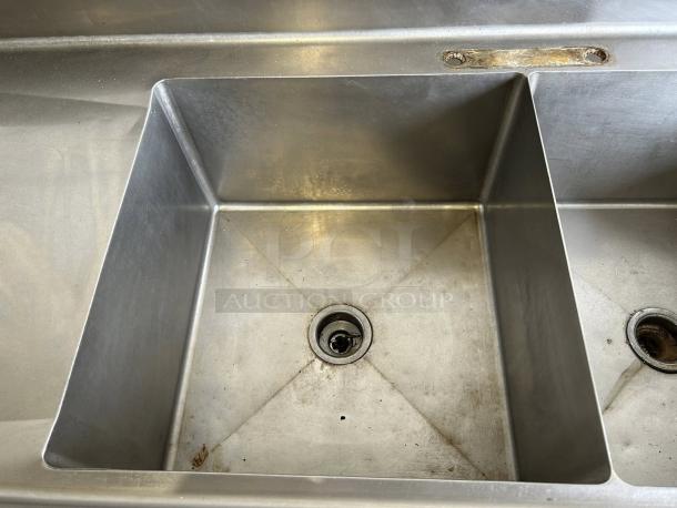 Commercial 3-compartment stainless steel sink with double drainboards, fully tested, in great condition.
